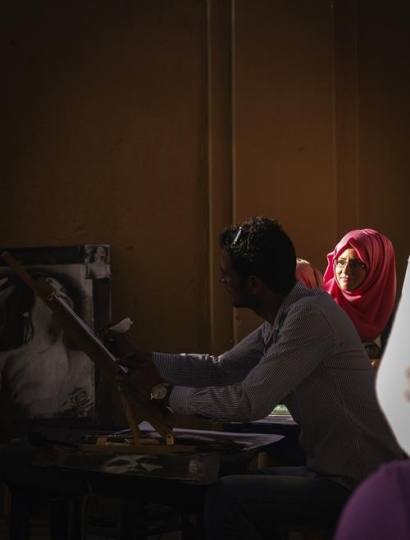 artist painting on canvas