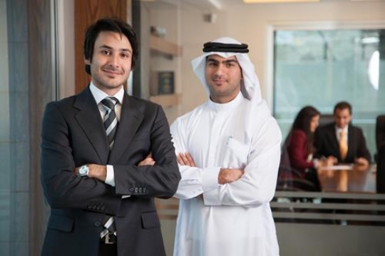 businessmen standing with hand crossed looking at camera