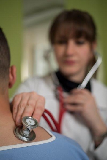 A Woman Doctor Examining Patient at Hospital