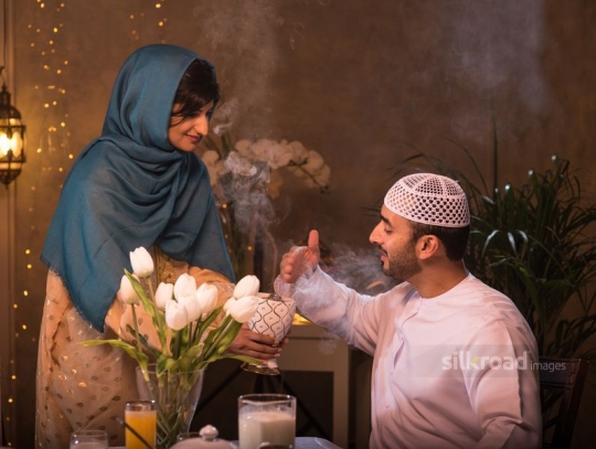 Middle Eastern woman spreading bakhoor 