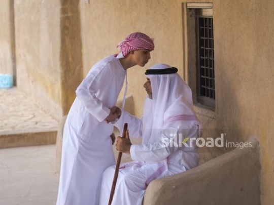 Teenager paying respect to grandfather|-