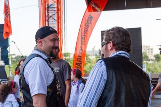 two men standing outside chatting and laughing