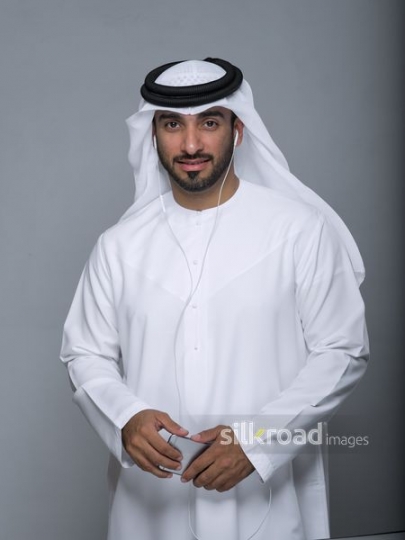 Middle Eastern man wearing earphones 