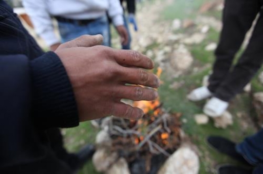 group of people near campfire at bab al-shams