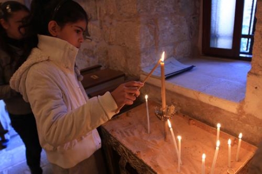 Little girls in church, lighting candles
