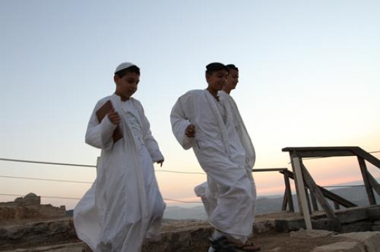 members of the Samaritan community march atop Mount Gerizim, above the West Bank city of Nablus,