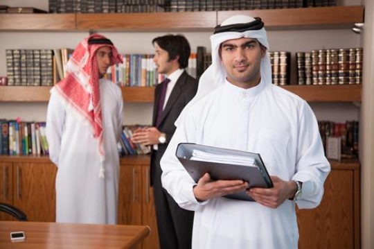 young businessman standing with folder