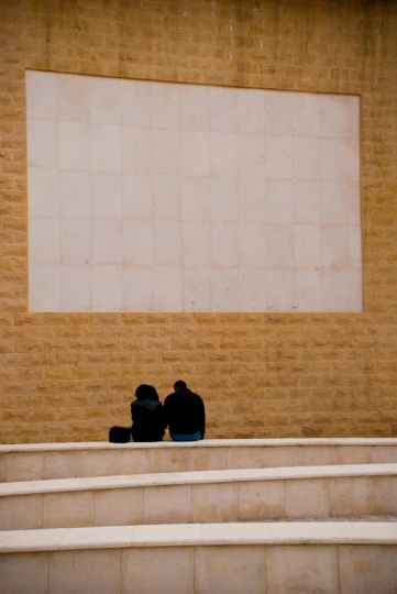 couple having a city break sit