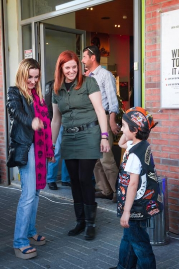 two pretty woman talking to a little boy