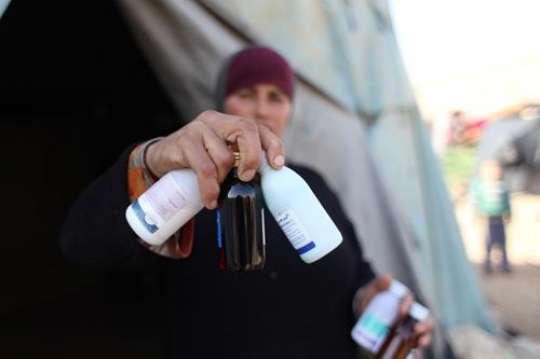 palestenian women with midicine in hand, Bad life situation