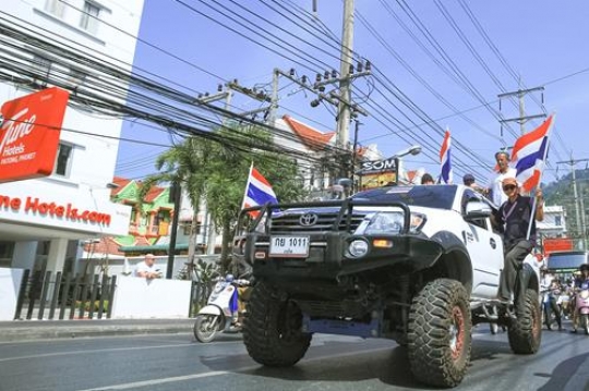 car carrying people with flags