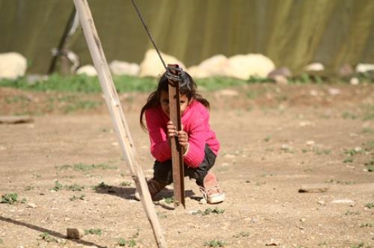 Cute little girl is playing with her brothers.
