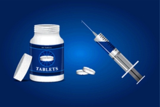 Medication,pills and syringe on blue background