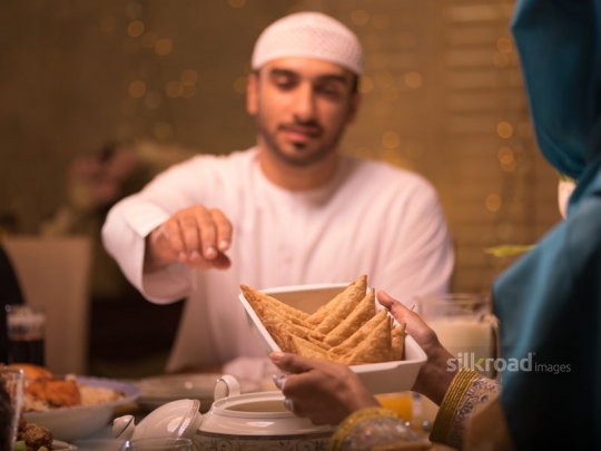 Wife serving husband food|-