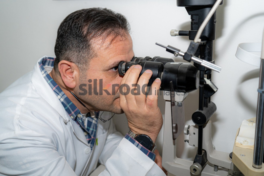Doctor Examining Patient's Eyes with Ophthalmoscope for Eye Health