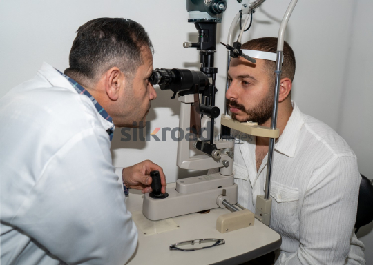 Doctor Examining Patient's Eyes with Ophthalmoscope for Eye Health