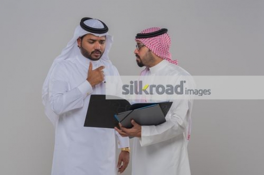 Middle Eastern men working together|