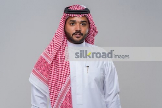 Medium shot of an Arab Businessman dressed in the traditional attire|