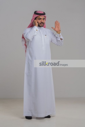 Middle Eastern man having a serious conversation on the phone