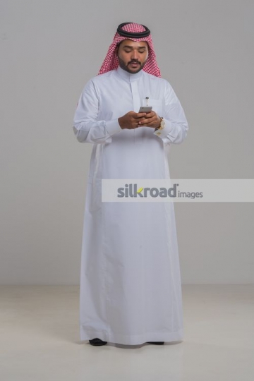 Middle Eastern Businessman using his phone|