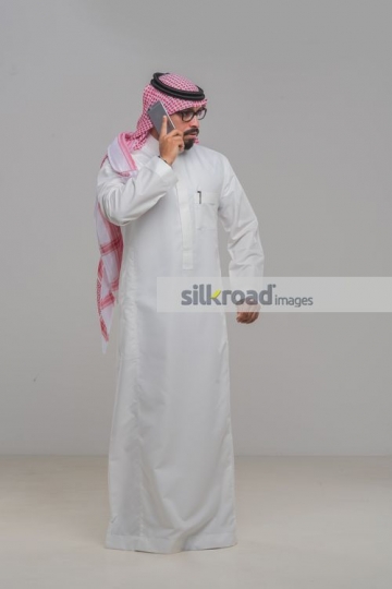 Businessman standing having a serious phone call