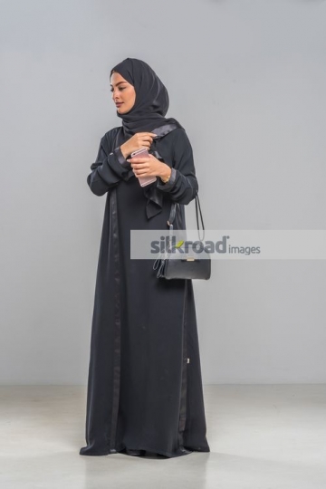 Businesswoman fixing Abaya|