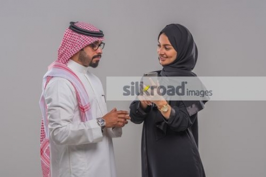 Middle Eastern man and woman talking