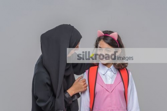 Middle Eastern woman talking to the young girl|