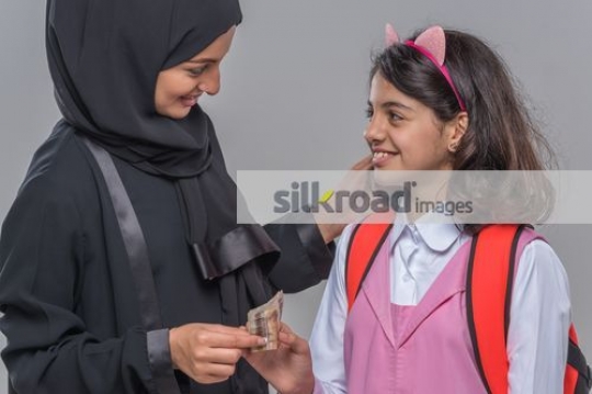 Middle Eastern woman with the young kid|