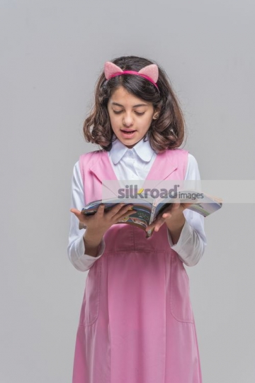 Young Arab girl reading the book|