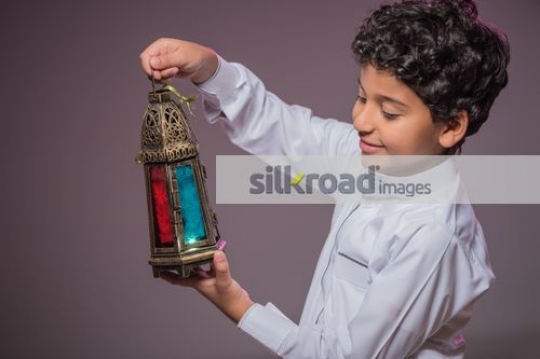 Young Arab boy carrying the Ramadan Lantern|