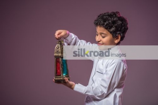 Arab boy carrying the Ramadan Lantern|