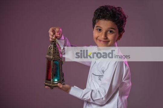 Middle Eastern boy carrying the Ramadan Lantern|