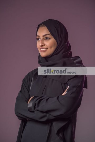 Middle Eastern woman crossing arms