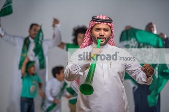 Middle Eastern family proudly celebrating their country|