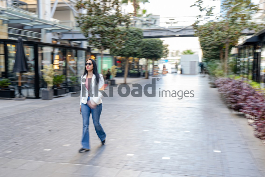 Dynamic Panning Shot of a Woman Walking at Amman’s Abdali Boulevard