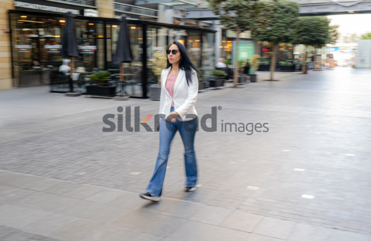 Dynamic Panning Shot of a Woman Walking at Amman’s Abdali Boulevard
