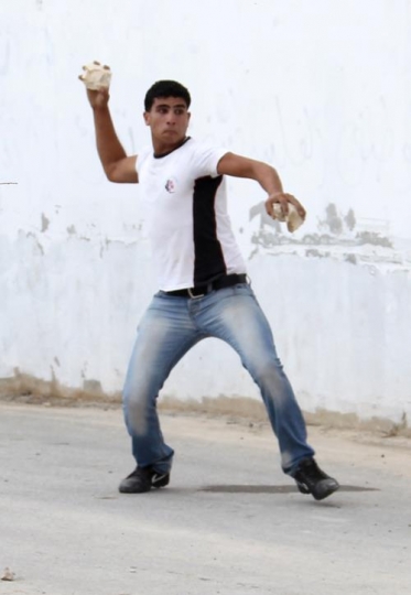 Palestinian throwing stones
