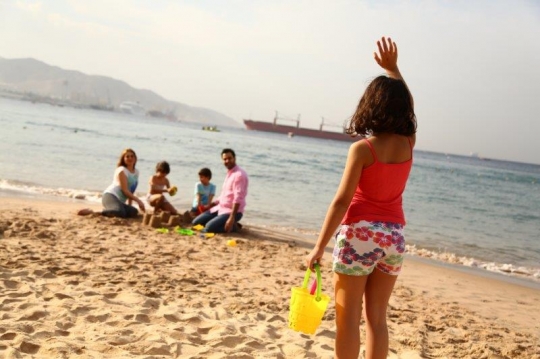 Family Having Fun By The Beach
