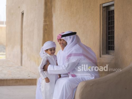 Grandfther picking up little boy|-