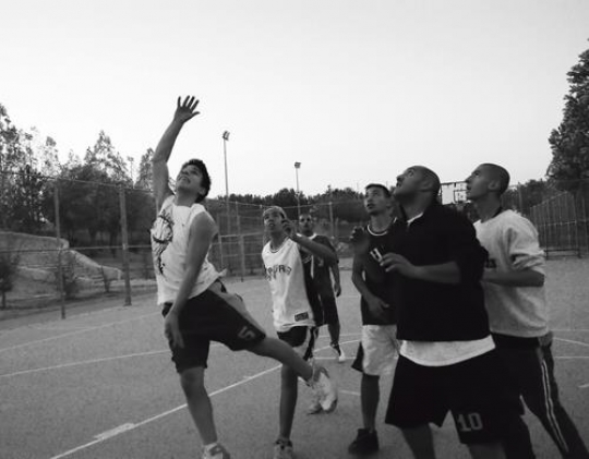young men playing basketball in king hussein park,jordan