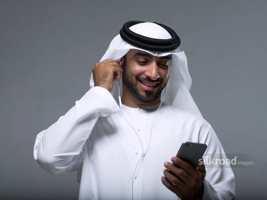 Arab Businessman on the phone using earphones