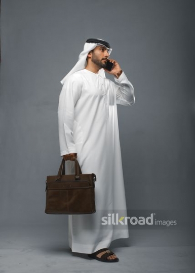 Arabian businessman getting directions over the phone