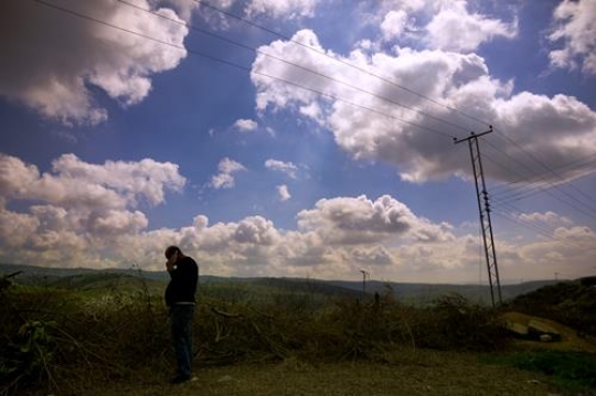 View of the town of Salt in Jordan, man talking on the mobile phone.