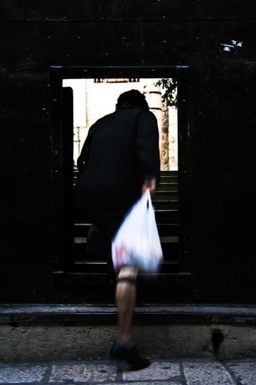muslim woman going upstairs holding bag,palestine