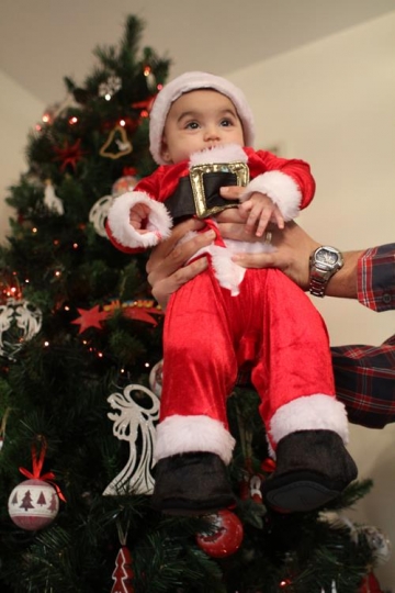 father holding up baby son