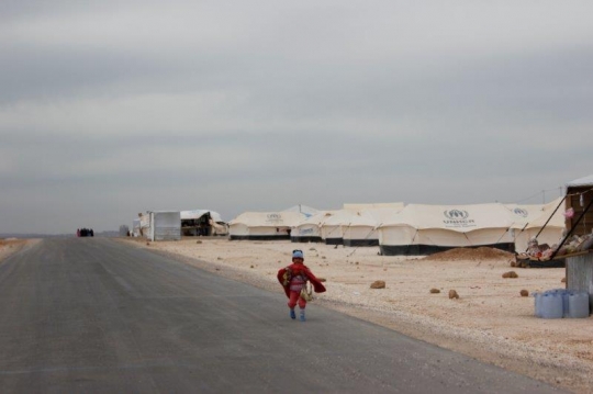 kid running in a refugee camp