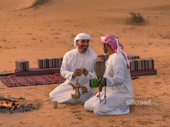 Man serving arabic coffee