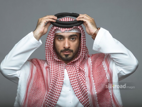 Arabian man fixing his head cover