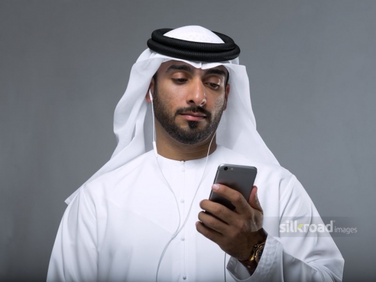 Arabian man checking his mobile phone